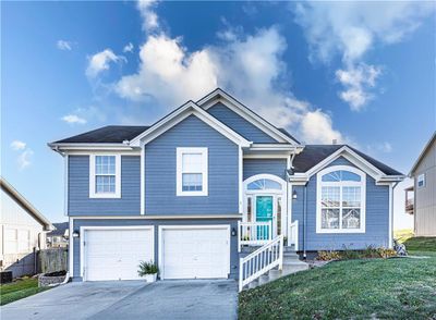 View of front of property with a garage and a front yard | Image 1