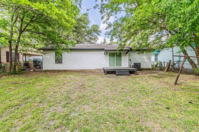 Back of house with a fenced backyard and a yard | Image 26