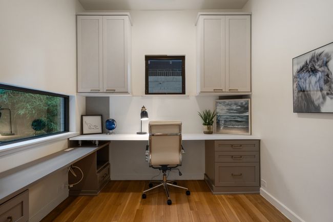 Office space with built in study area, light wood-style flooring, and baseboards | Image 29