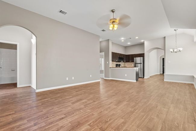Unfurnished living room looking toward the kitchen. | Image 12