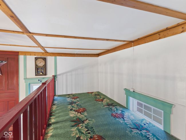 interior space with beamed ceiling and carpet | Image 23