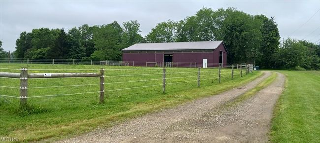 Stable featuring a view of rural / pastoral area and a view of trees | Image 18
