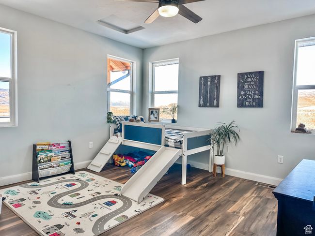 Bedroom featuring dark wood-type flooring, ceiling fan, baseboards, and attic access | Image 20