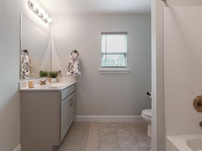 Bathroom featuring vanity, toilet, and tile patterned floors | Image 24