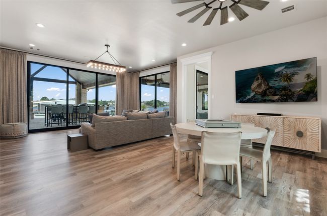Dining space featuring floor to ceiling windows, a ceiling fan, light wood finished floors, and recessed lighting | Image 14