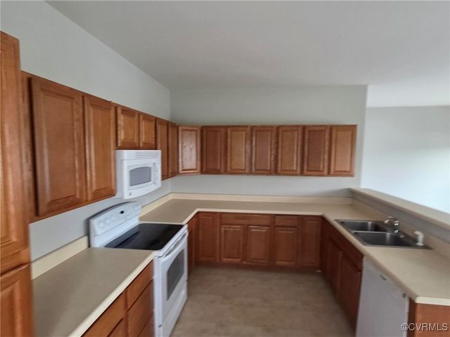 Laundry room with a sink, laundry area, water heater, and washer hookup | Image 21