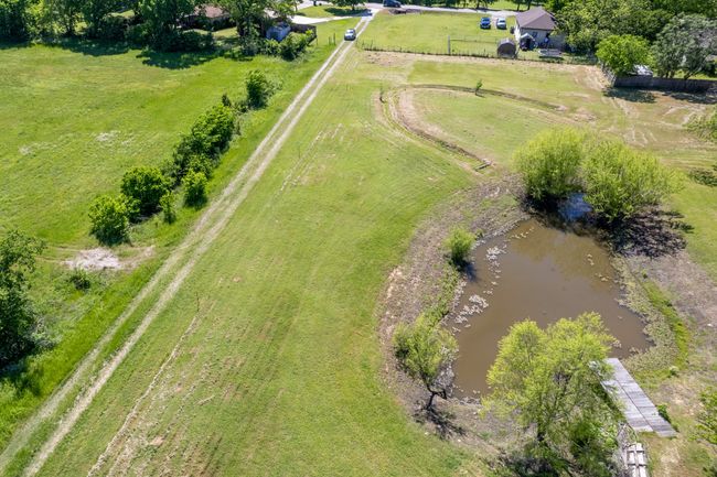 Aerial view of sparsely populated area featuring a large body of water | Image 14