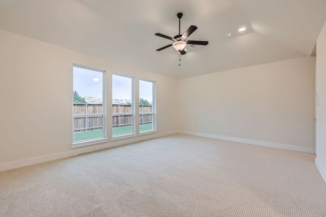 Empty room with light carpet, baseboards, and a ceiling fan | Image 17
