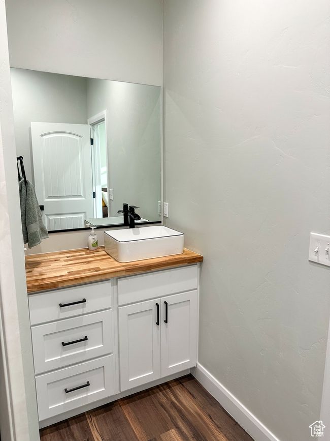 Bathroom featuring baseboards, wood finished floors, and vanity | Image 31