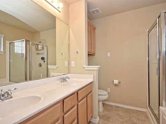 Full bathroom featuring double sink, and a stall shower | Image 14