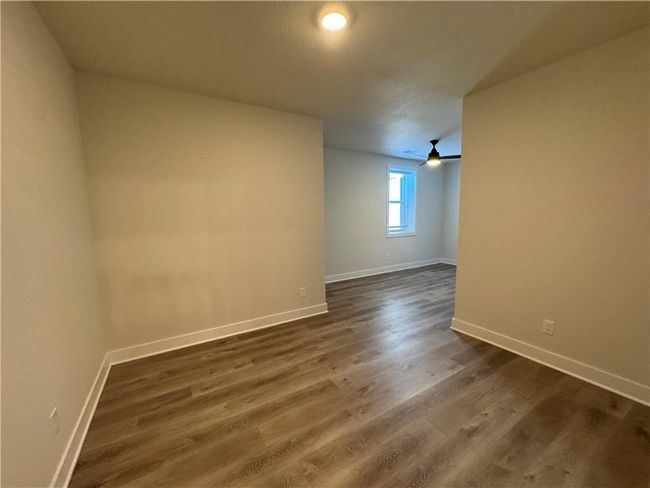 Unfurnished room featuring baseboards and dark wood-style floors | Image 56