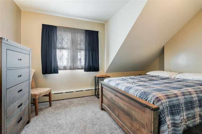 Bedroom featuring baseboard heating and carpet floors | Image 24