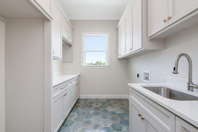 Laundry area featuring cabinet space, electric dryer hookup, and hookup for a washing machine | Image 25