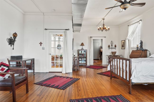 Bedroom featuring a chandelier, multiple windows, ornamental molding, and hardwood / wood-style flooring | Image 34