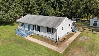 View of front of property featuring a front yard and an outdoor structure | Image 1