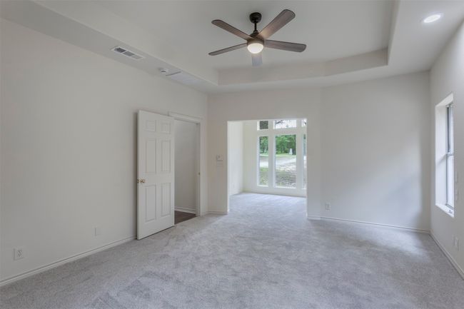 Spare room featuring plenty of natural light, carpet flooring, and a ceiling fan | Image 18