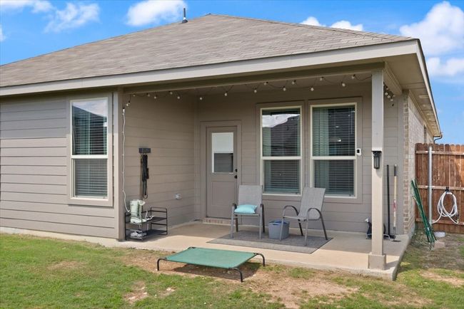 Back of house with a patio, fence, and a shingled roof | Image 32