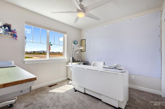 Carpeted office featuring ceiling fan and baseboards | Image 21