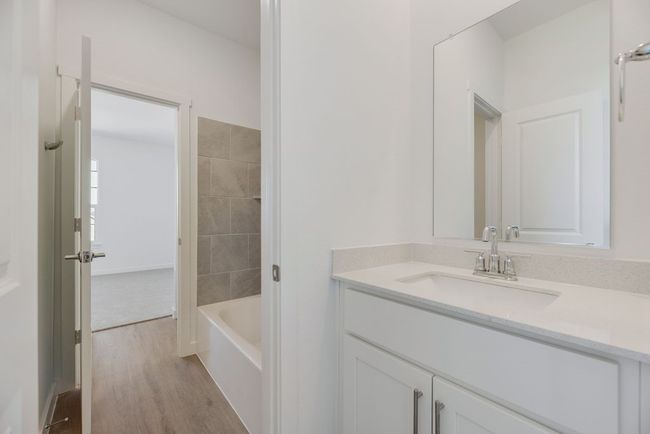 Bathroom with vanity, wood finished floors, and shower combination | Image 9