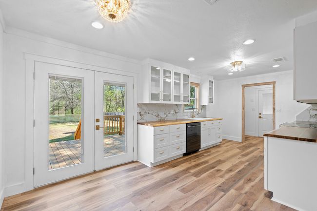 Kitchen featuring butcher block countertops, visible vents, recessed lighting, white cabinetry, and french doors | Image 16