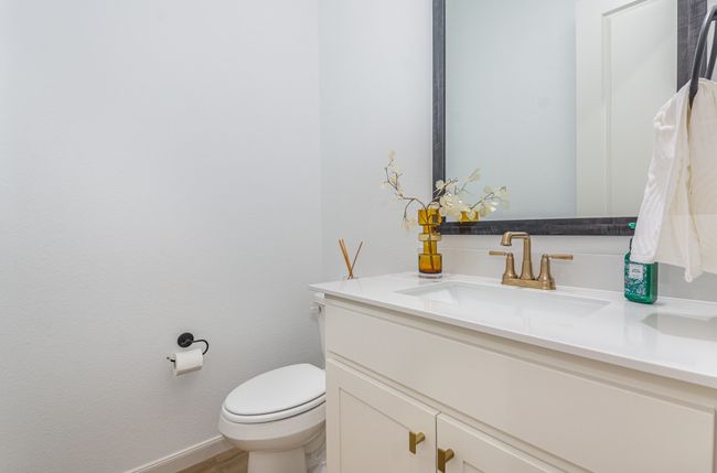 Half bathroom with vanity and wood finished floors | Image 15