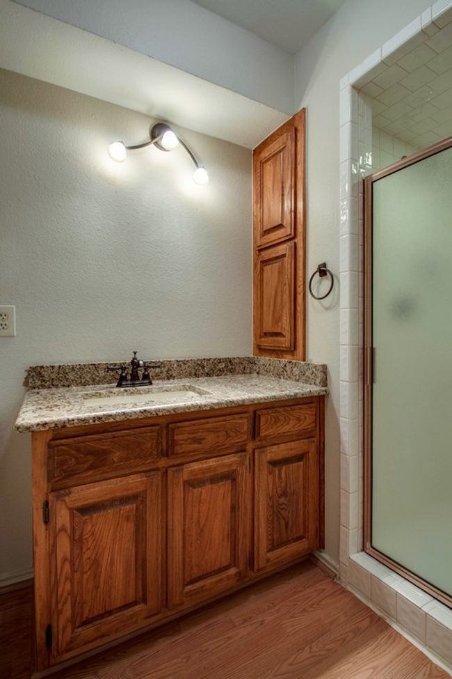 Full bath with a stall shower, wood finished floors, and vanity | Image 9