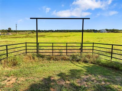 View of pipe fence entry with a rural view | Image 2