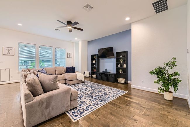 Living room featuring a ceiling fan, wood finished floors, and recessed lighting | Image 7