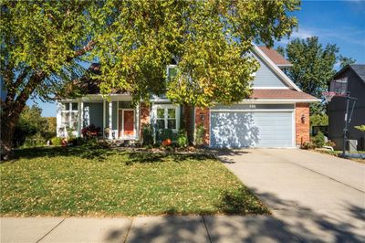 View of property hidden behind natural elements featuring a front lawn | Image 2