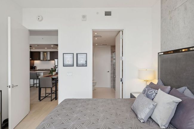 Bedroom with light wood-style flooring and connected bathroom | Image 21