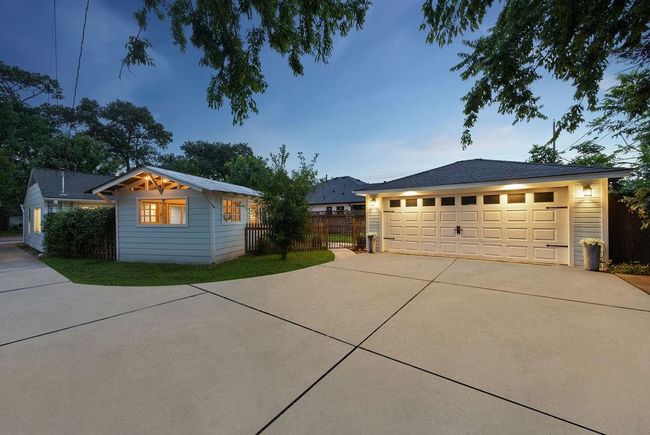 The extra spacious driveway provides plenty of room for off-street parking, and the 2-car garage is a wonderful addition to this beautiful cottage. | Image 25