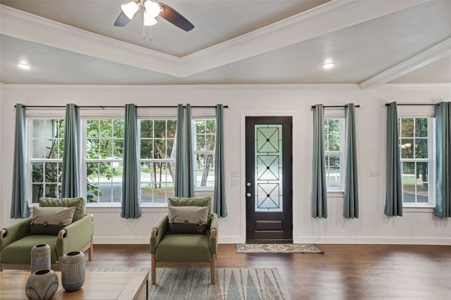 Foyer featuring wood finished floors, crown molding, and ceiling fan | Image 8