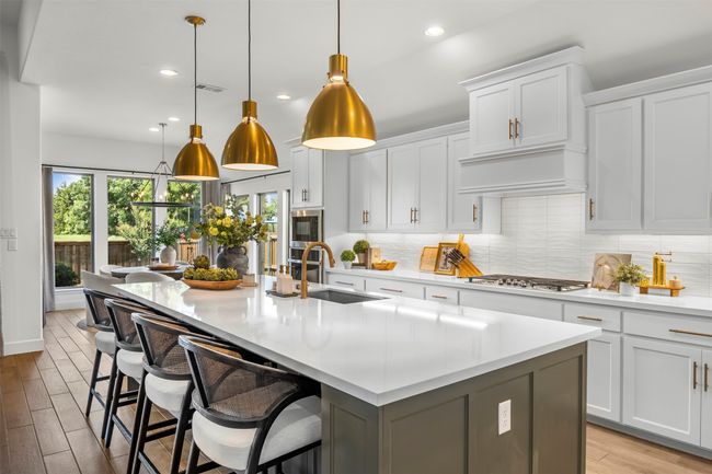 Kitchen with healthy amount of natural light, backsplash, light countertops, and recessed lighting | Image 8