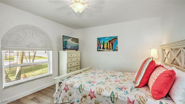 Guest Bedroom downstairs with wood finished floors and ceiling fan | Image 22
