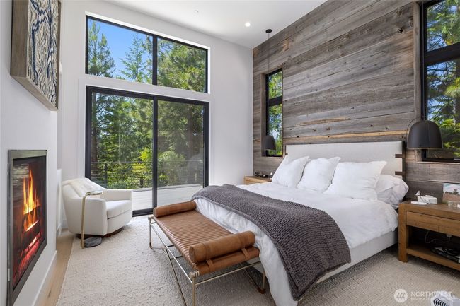 Primary on main floor w/old barnwood accent wall. | Image 14