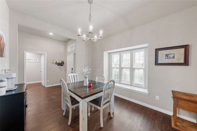 Dining room with a chandelier, baseboards, and dark wood-style floors | Image 5
