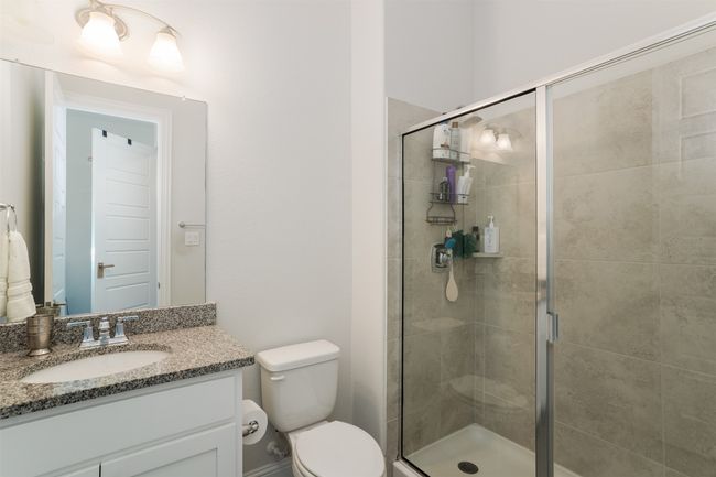 Full bathroom featuring a shower stall, toilet, and vanity | Image 30