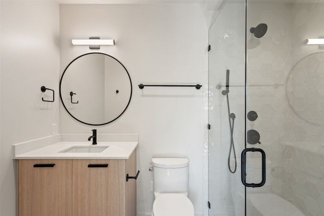 Full bath featuring toilet, a shower stall, and vanity | Image 28