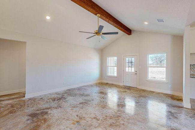 Unfurnished living room with ceiling fan, finished concrete flooring, and recessed lighting | Image 12