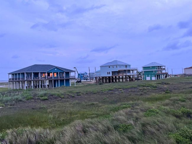 As evening settles in, this view captures the peaceful rhythm of life in Seahorse Estates. With soft glows from porch lights and the natural soundtrack of the Gulf, this is the kind of place where neighbors wave, sunsets matter, and every night feels like a vacation. | Image 18