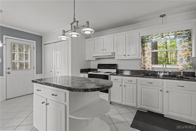 Kitchen featuring a sink, electric range, open shelves, under cabinet range hood, and light tile patterned floors | Image 15