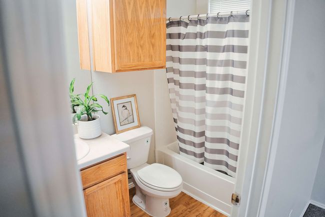 Full bathroom featuring vanity, shower / tub combo with curtain, and wood finished floors | Image 21