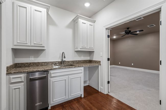 Beverage bar outside media room with built-in ice maker and room for mini-fridge | Image 24