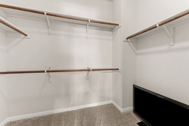 Spacious closet featuring light colored carpet | Image 14