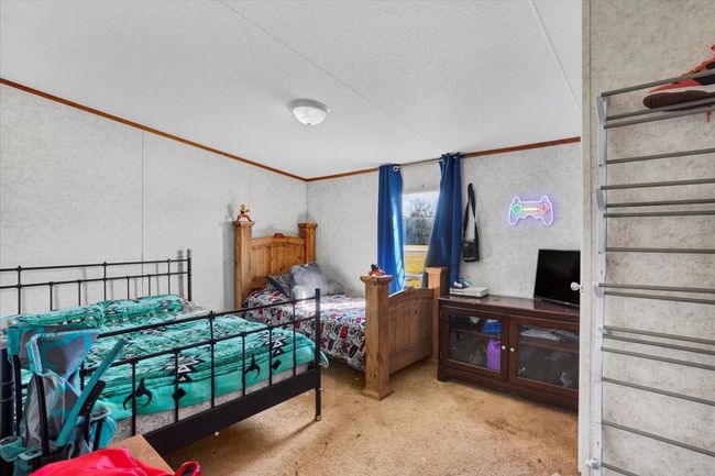 Bedroom featuring a textured ceiling, carpet floors, and crown molding | Image 21