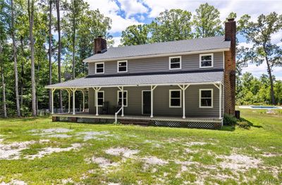 Farmhouse-style home with a swimming pool and a front yard | Image 1