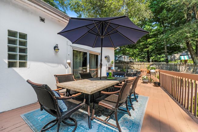 Deck with outdoor dining area and fence | Image 38