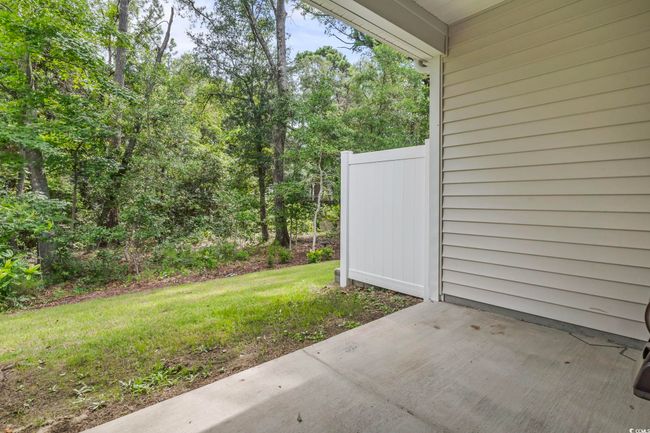 View of green lawn with a patio area | Image 15