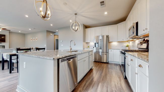 The large island holds the sink and dishwasher | Image 12