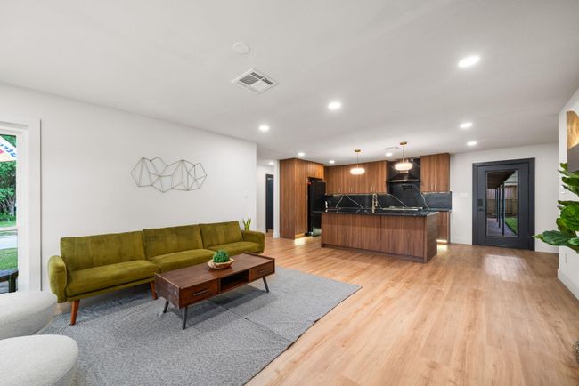 The flow of the space offers plenty of elbow room. Notice the under-cabinet and toe kick lighting in the kitchen. | Image 11